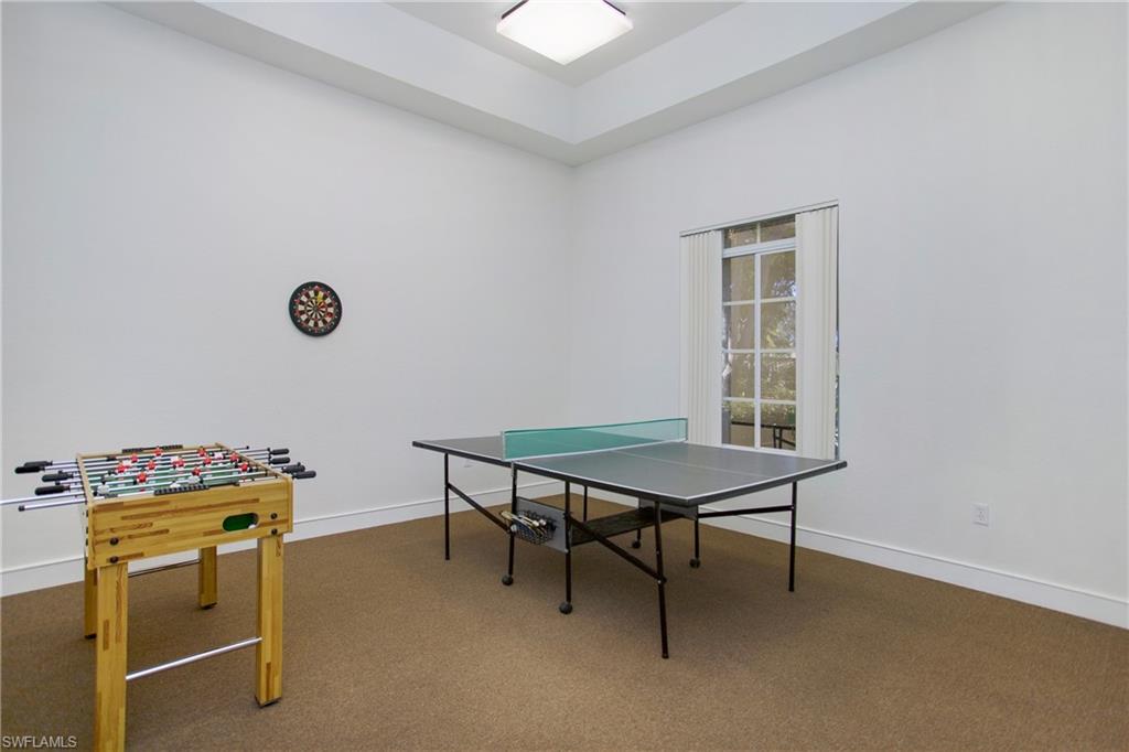 8244 Key Royal Circle, Unit 615 Naples, FL 34119 - Photo 23 of 23 Playroom with carpet and a raised ceiling