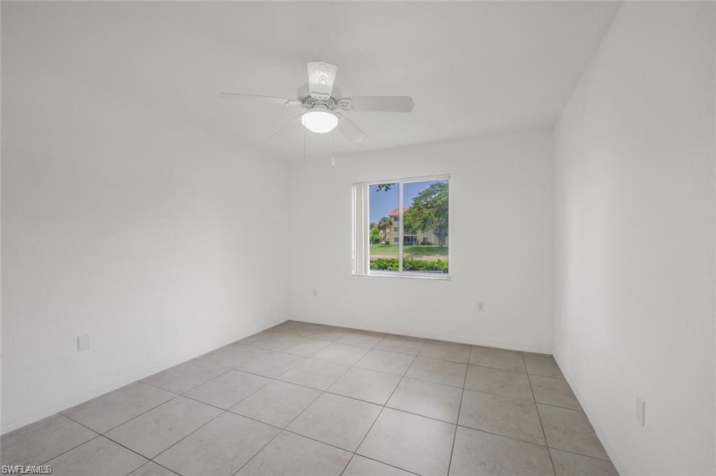 8244 Key Royal Circle, Unit 615 Naples, FL 34119 - Photo 9 of 23 Unfurnished room featuring light tile patterned floors and a ceiling fan
