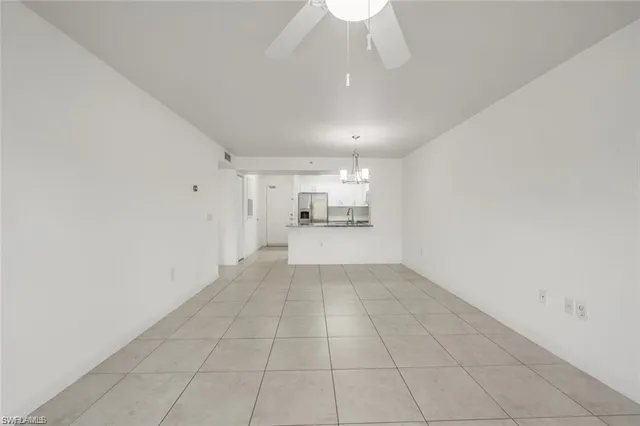 a view of a livingroom with an empty space and a window