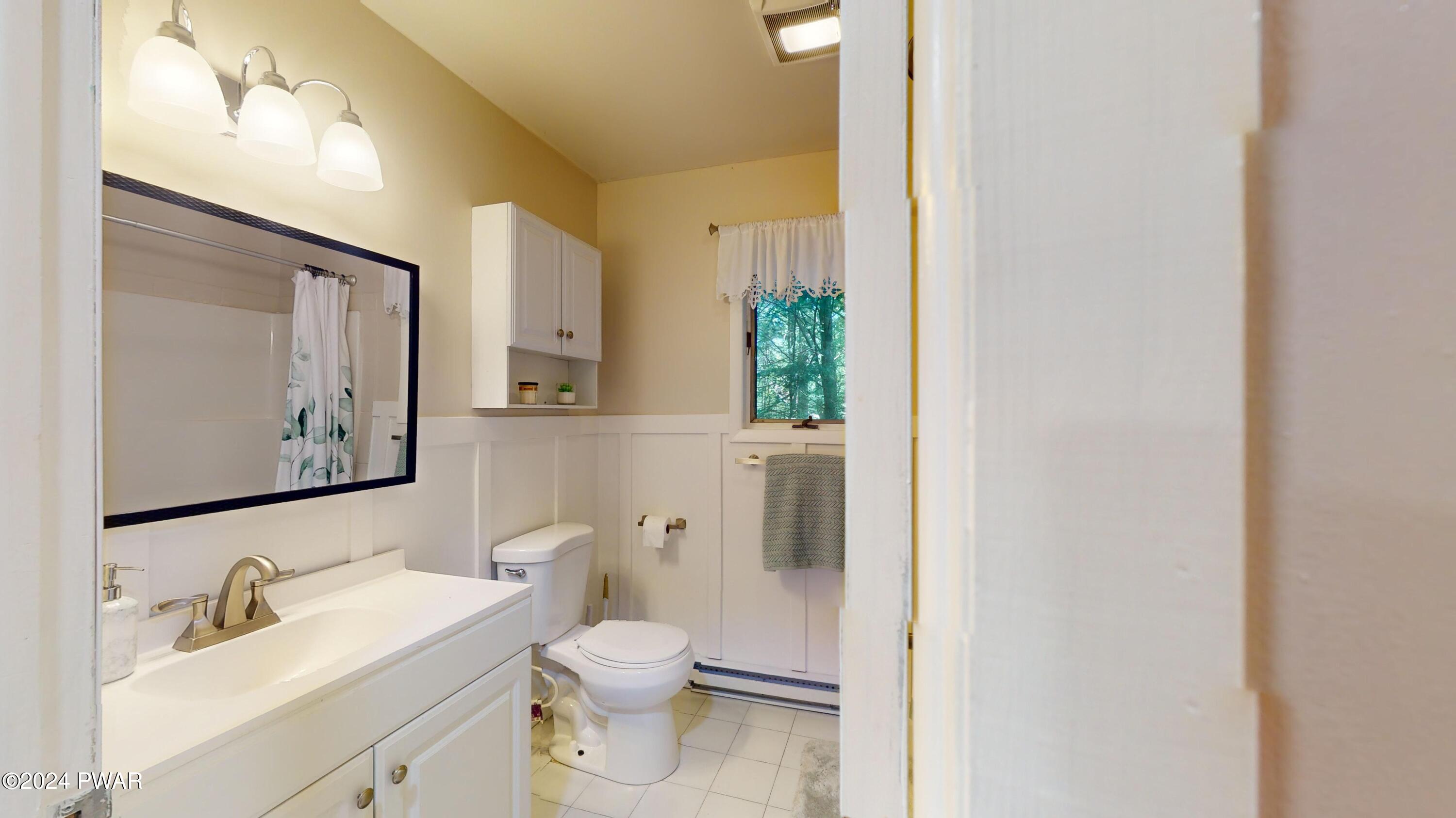 135 Fox Road Dingmans Ferry, PA 18328 - Photo 18 of 24 a bathroom with a toilet sink and mirror
