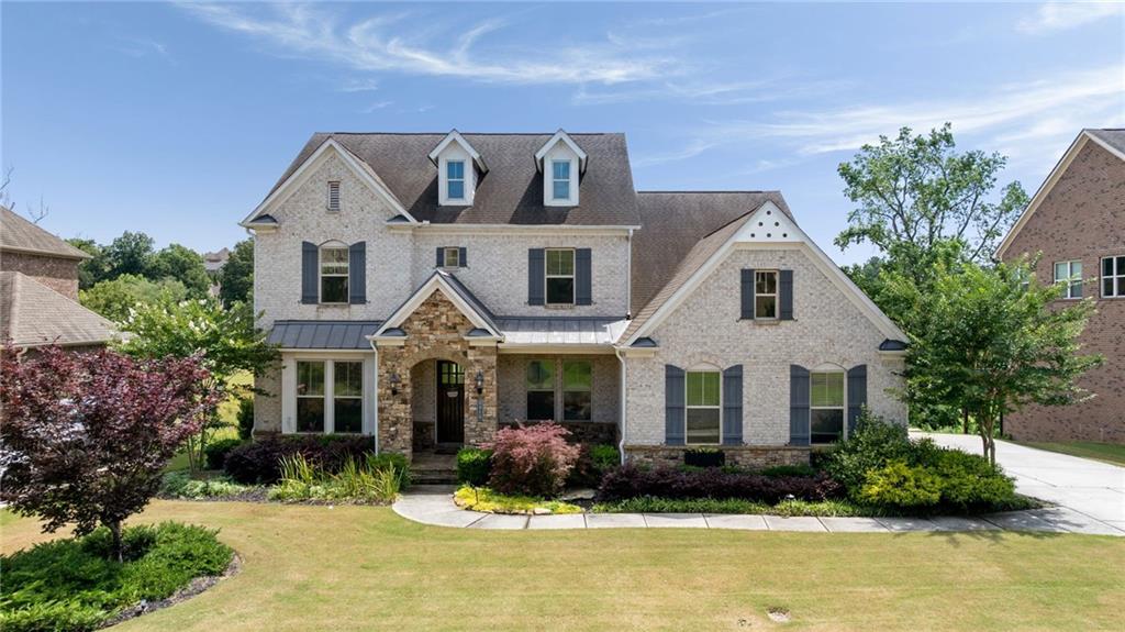 a front view of a house with yard and green space