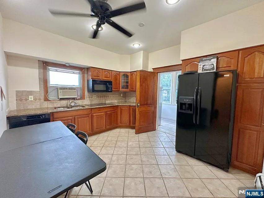 a kitchen with stainless steel appliances granite countertop a refrigerator a sink and a stove