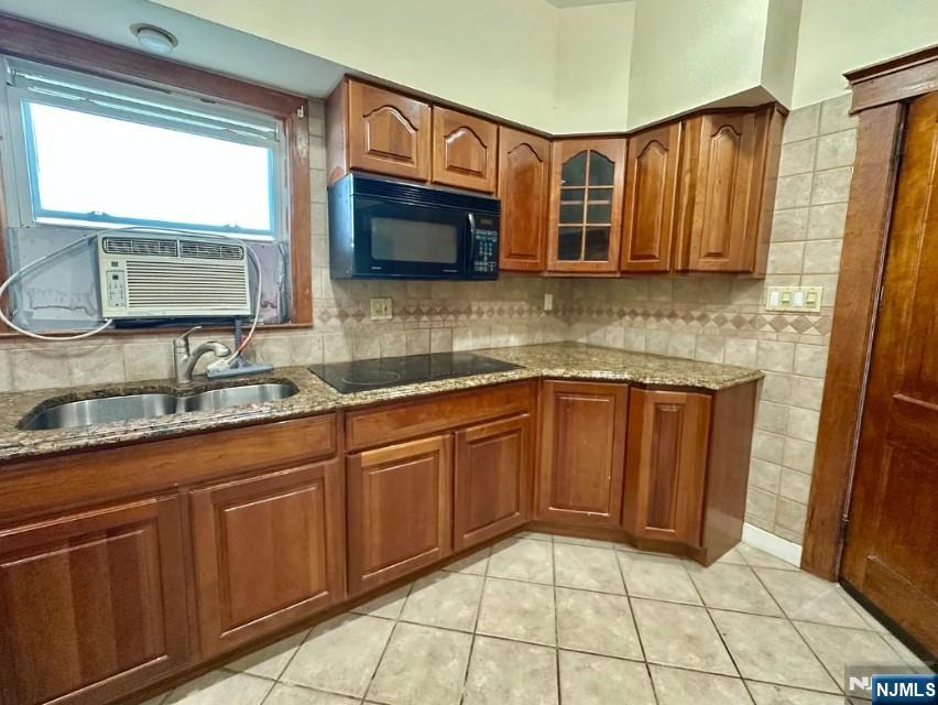 270 Pacific Street, Unit 3 Paterson, NJ 07503 - Photo 2 of 8 a kitchen with stainless steel appliances granite countertop wooden cabinets a sink and a window