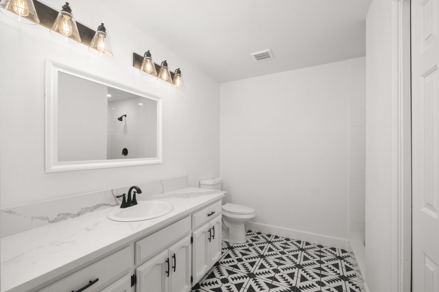 42906 Ranger Cir Drive Coarsegold, CA 93614 - Photo 14 of 29 a bathroom with a granite countertop sink and a mirror