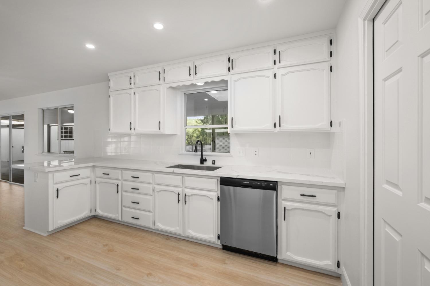 42906 Ranger Cir Drive Coarsegold, CA 93614 - Photo 10 of 29 a kitchen with white cabinets white appliances sink and dishwasher