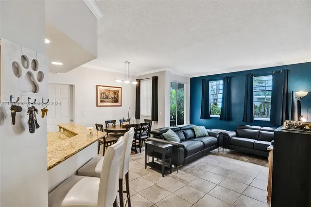 a living room with furniture and large windows