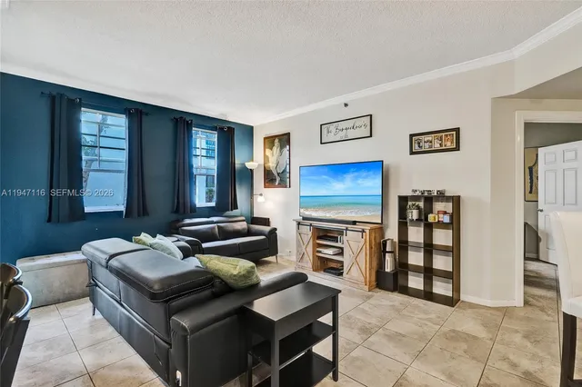 a living room with furniture a ceiling fan and a window