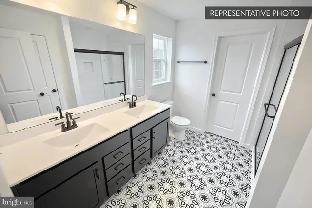 a picture of a bathroom with a glass shower door