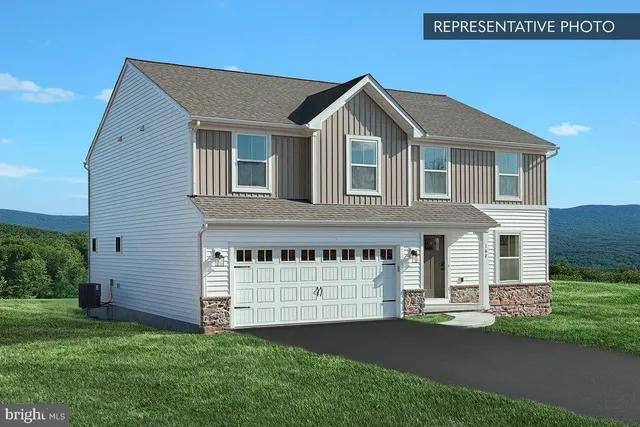 a front view of a house with a garden and yard