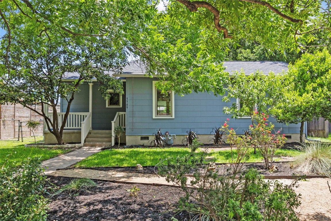 Undisclosed Address Austin, TX 78752 - Photo 1 of 1 a front view of a house with garden