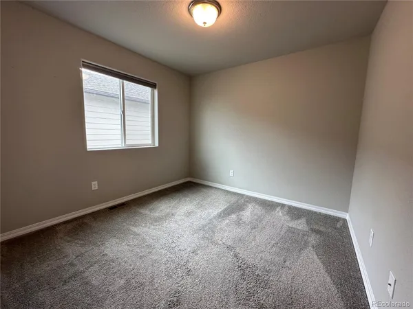 an empty room with windows and with windows