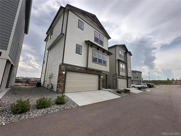 a couple of cars parked in front of a house