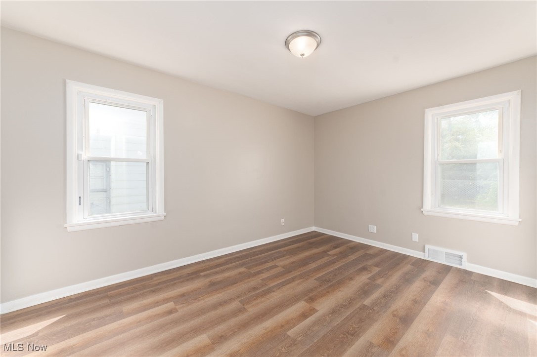 370 South Green Road Cleveland, OH 44121 - Photo 17 of 34 Unfurnished room with a healthy amount of sunlight and hardwood / wood-style flooring