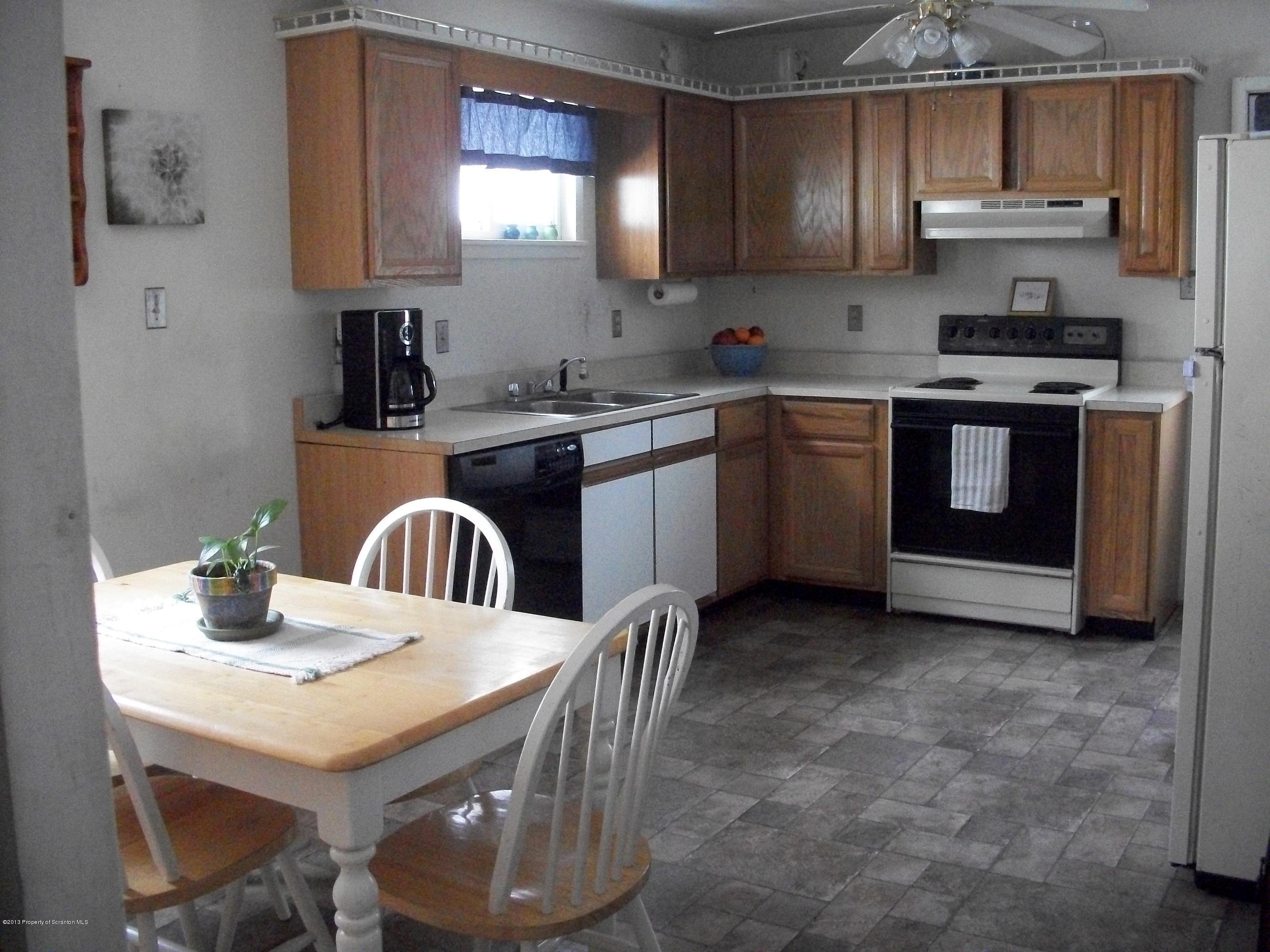 948 State Rte 3010 Springville, PA 18844 - Photo 4 of 7 a kitchen with stainless steel appliances granite countertop a stove a sink a microwave and cabinets