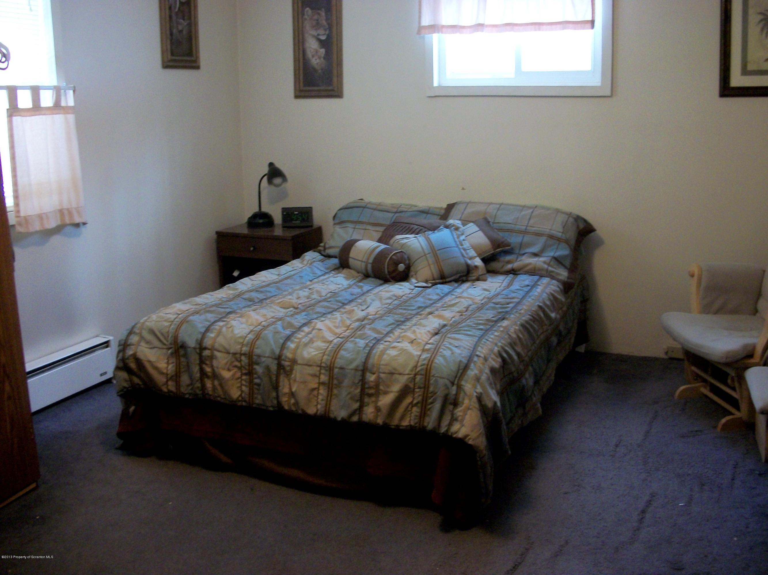 948 State Rte 3010 Springville, PA 18844 - Photo 7 of 7 a bed sitting in a bedroom next to a window