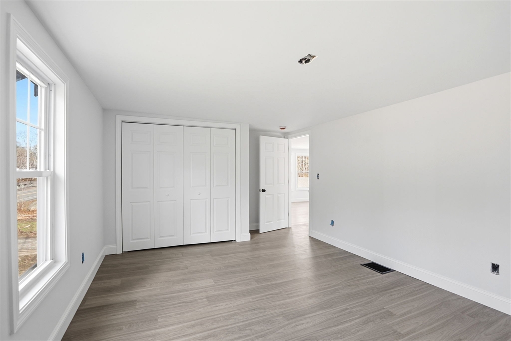 357 Wareham Street Middleboro, MA 02346 - Photo 33 of 42 a view of an empty room with wooden floor and a window