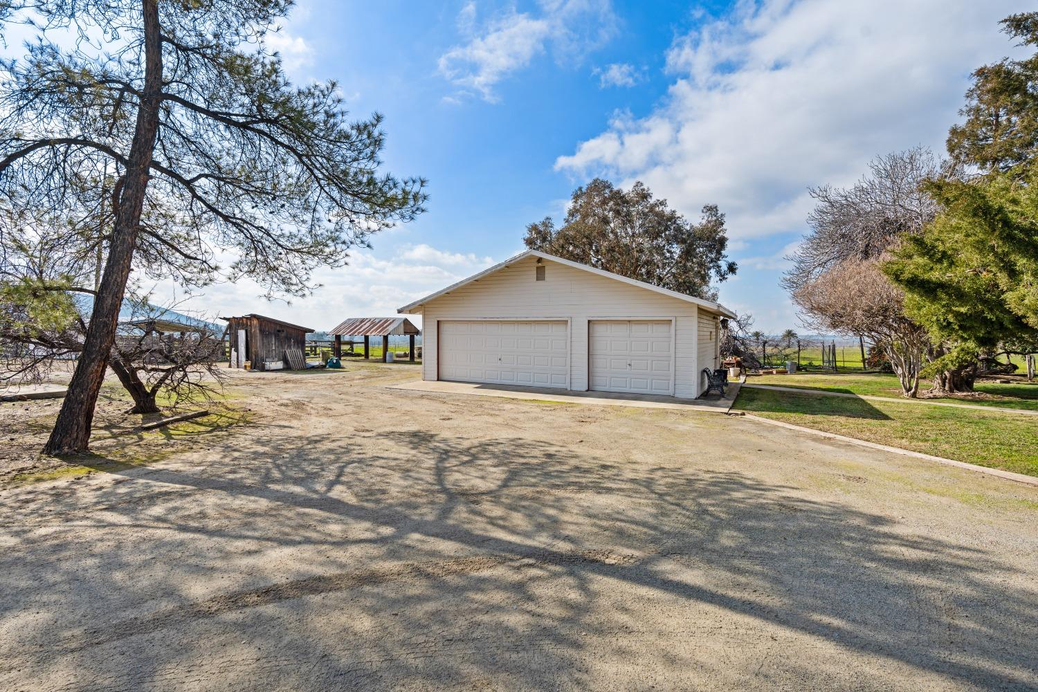 1790 North Piedra Road Sanger, CA 93657 - Photo 20 of 32 a front view of a house with a yard and garage