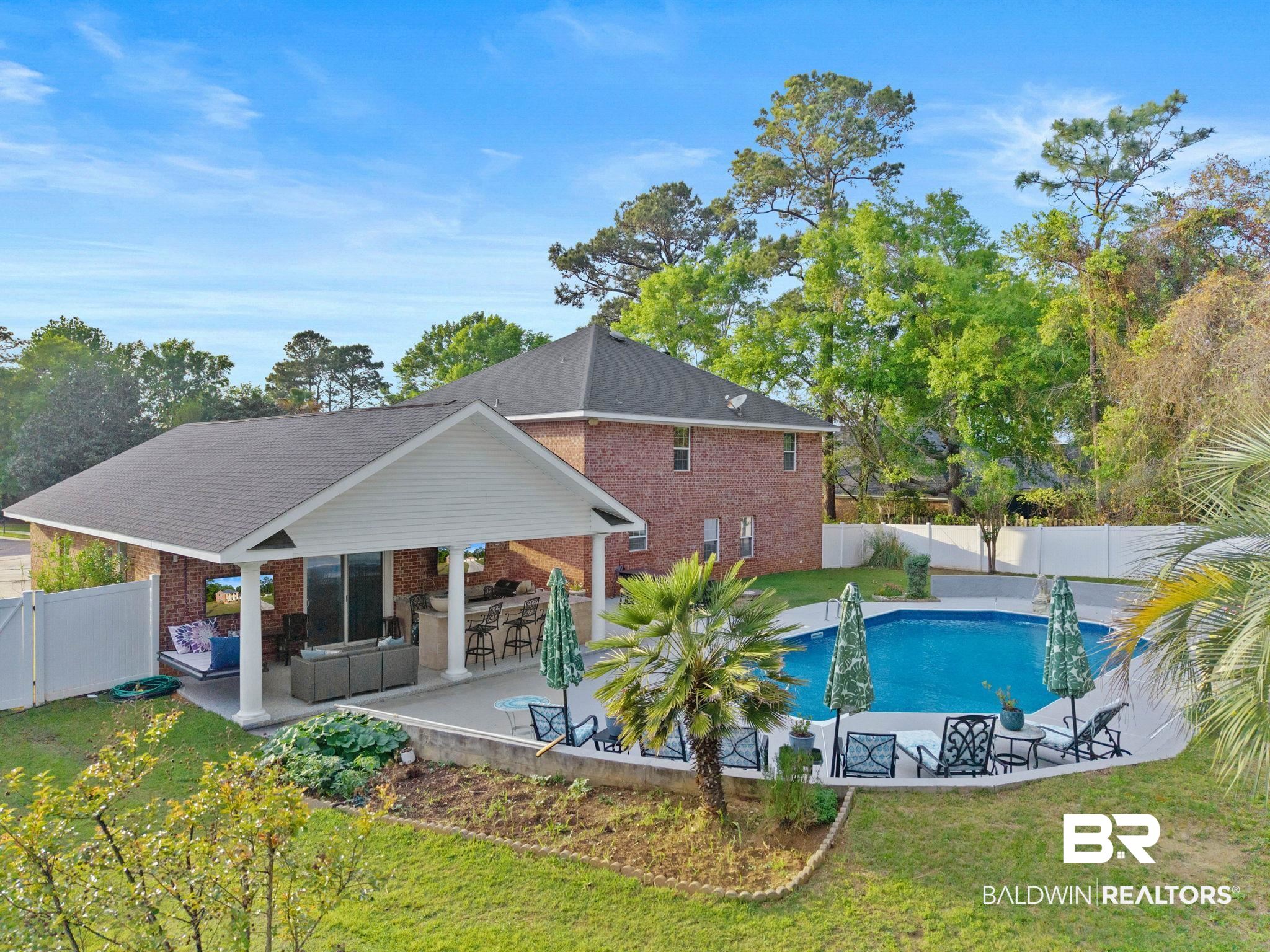 2 Speckle Trout Route Daphne, AL 36527 - Photo 57 of 61 View of pool with a fenced backyard, an outdoor lounge area with bar, patio surround, and a gate
