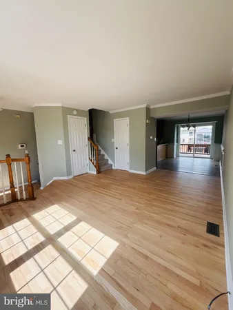 a big room with wooden floor and windows