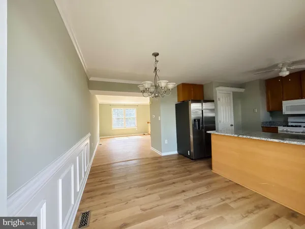 a view of a kitchen with a sink and a refrigerator