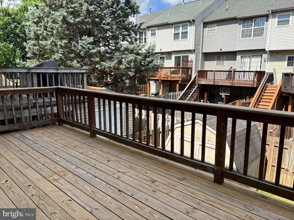 a view of balcony with wooden floor and fence