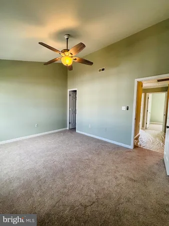 a view of a house with a ceiling fan and a window