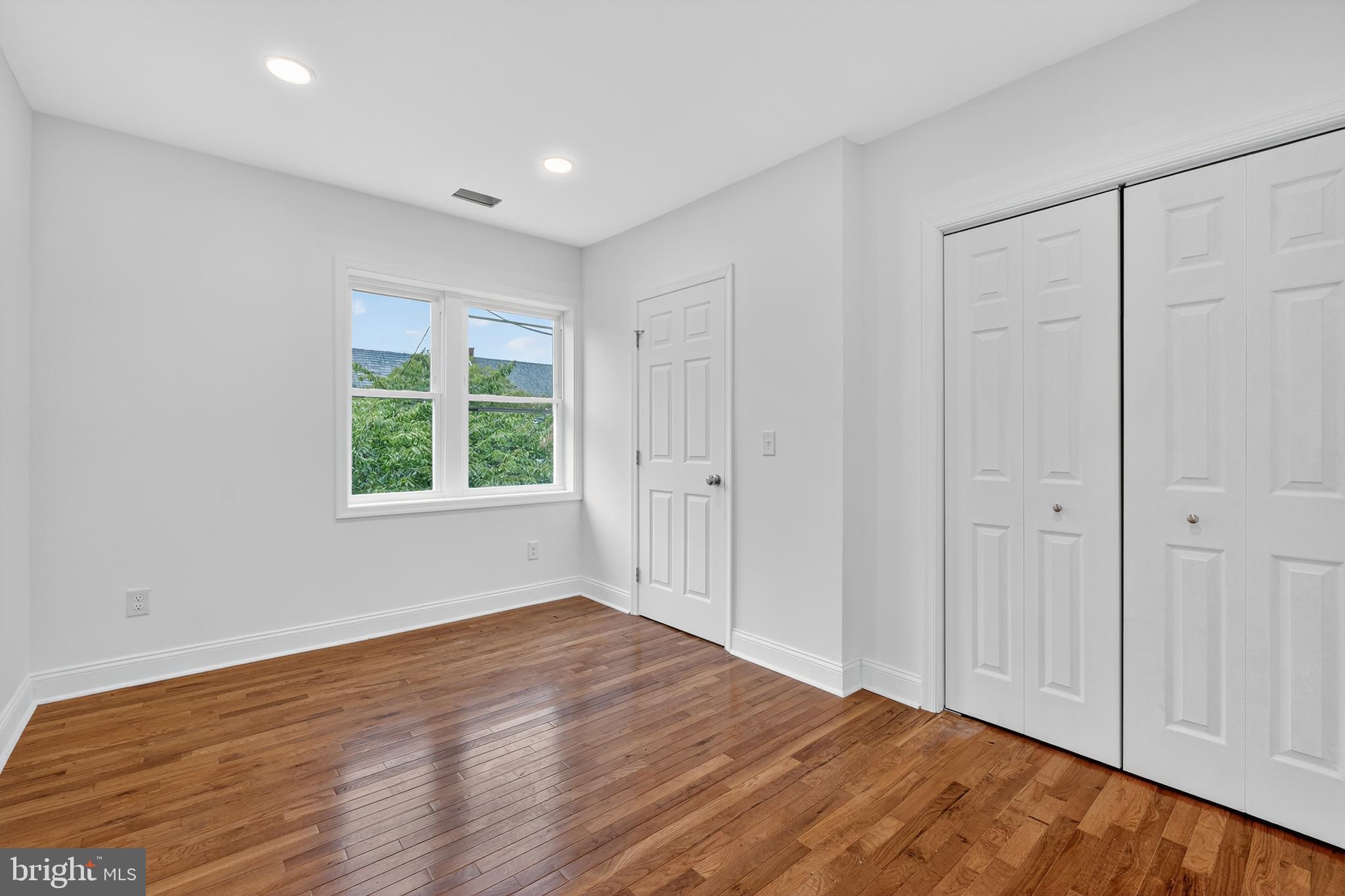 2932 Nelson Place Southeast, Unit 1 Washington, DC 20019 - Photo 12 of 18 a view of an empty room with wooden floor and a window