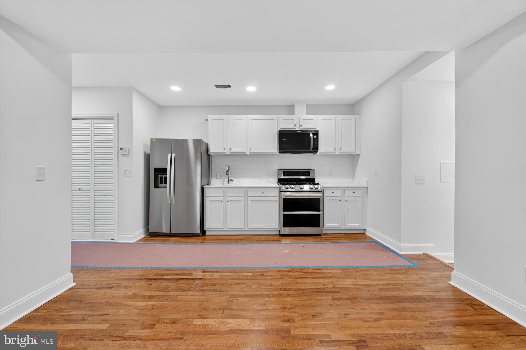 2932 Nelson Place Southeast, Unit 1 Washington, DC 20019 - Photo 5 of 18 a kitchen with stainless steel appliances a refrigerator and a stove top oven