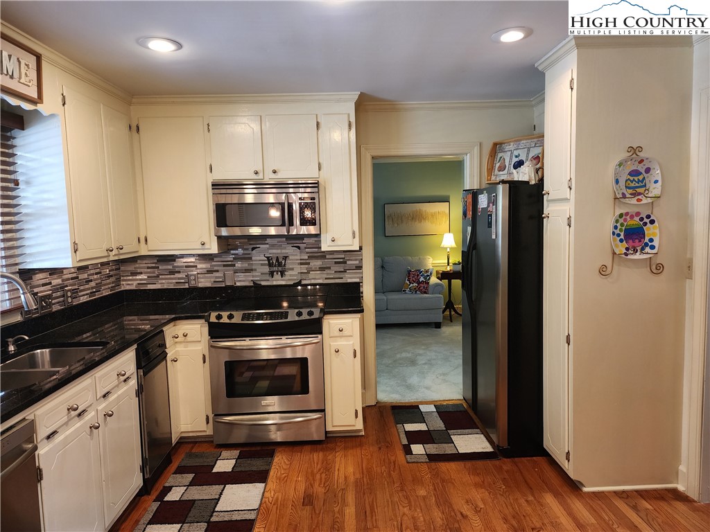 305 Old Farms Road Wilkesboro, NC 28697 - Photo 20 of 50 a kitchen with a stove and a refrigerator