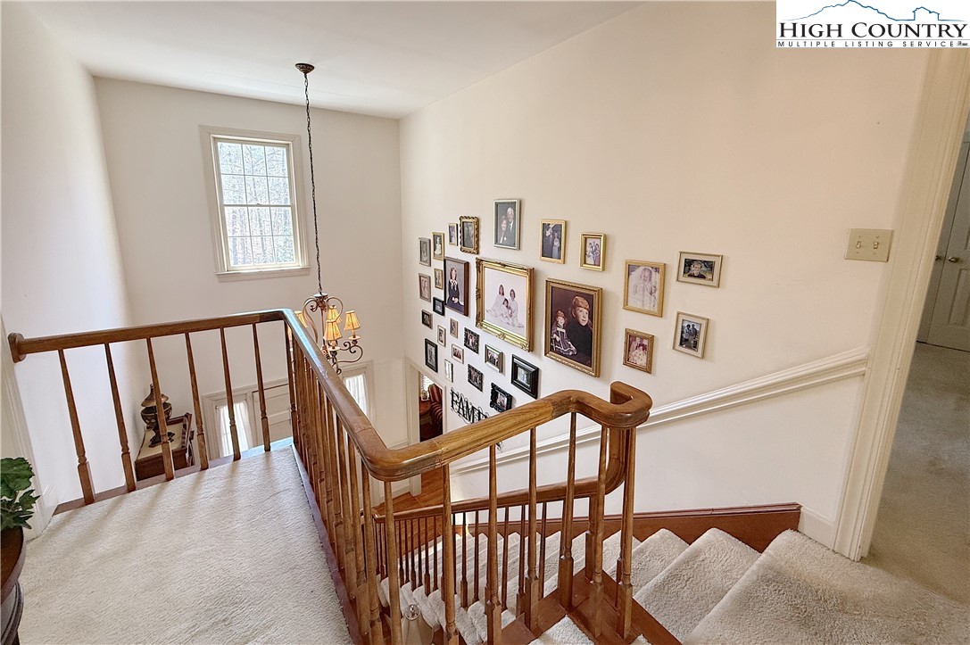 305 Old Farms Road Wilkesboro, NC 28697 - Photo 28 of 50 a view of staircase with lots of frames on wall and a window