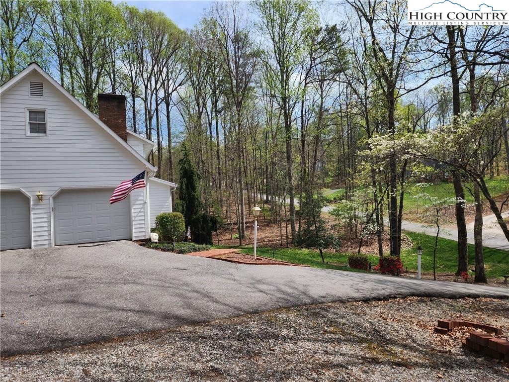 305 Old Farms Road Wilkesboro, NC 28697 - Photo 5 of 50 a front view of a house with a yard and garage