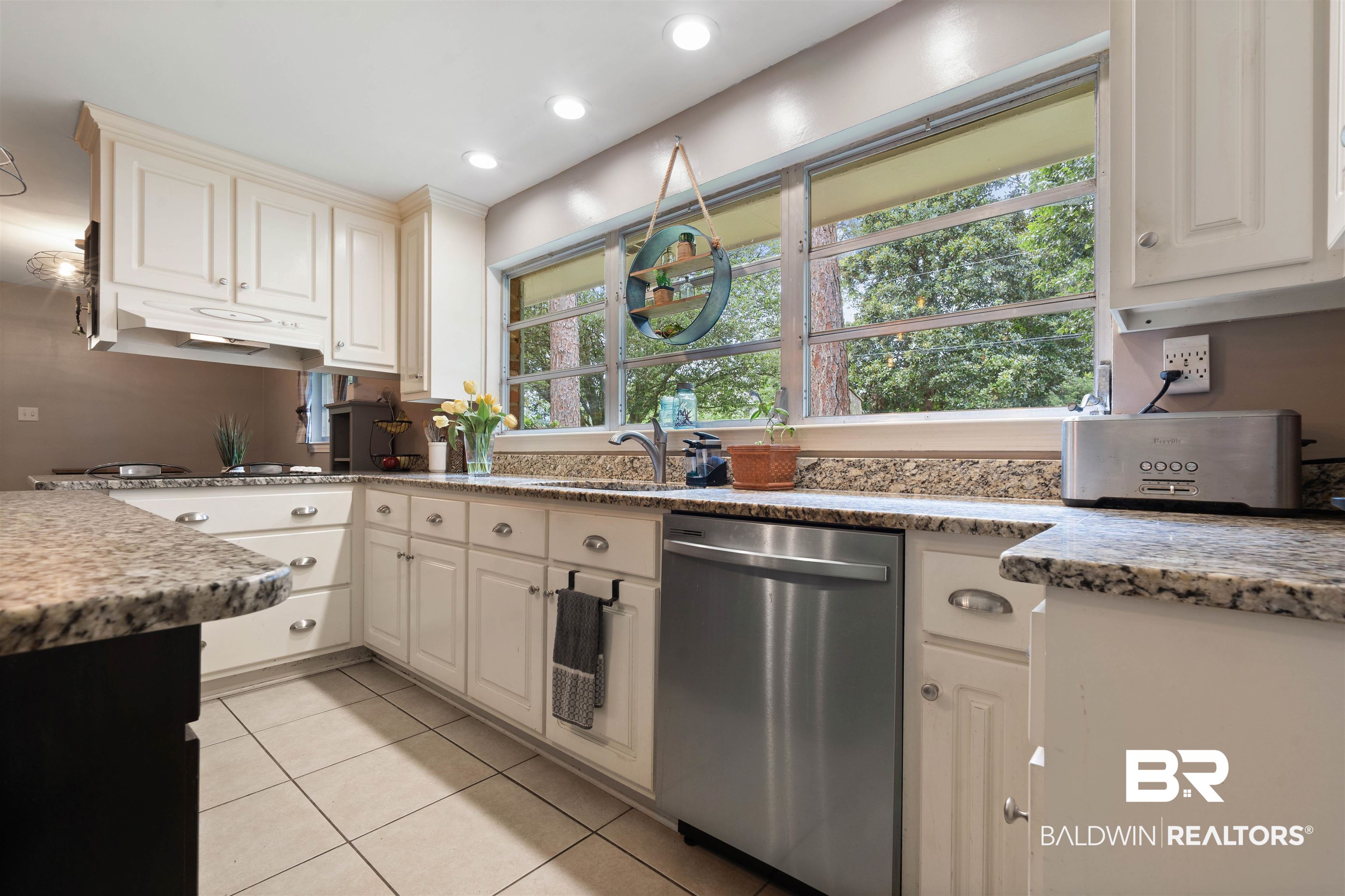 4051 East Canal Circle Mobile, AL 36619 - Photo 11 of 32 Kitchen featuring light tile patterned flooring, white cabinetry, dishwasher, light stone counters, and sink