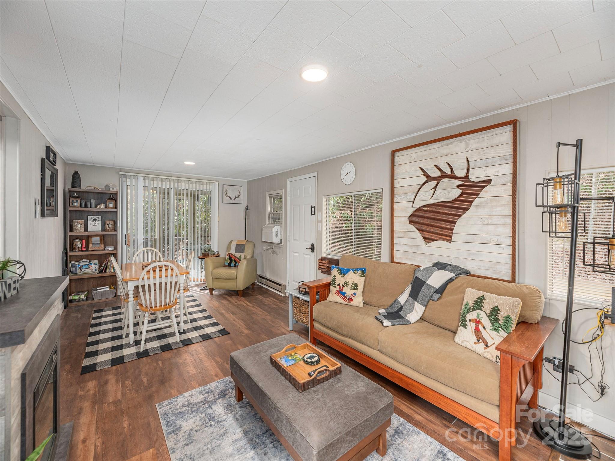 155 Mull Cove Road Maggie Valley, NC 28751 - Photo 7 of 19 a living room with furniture fireplace and a window