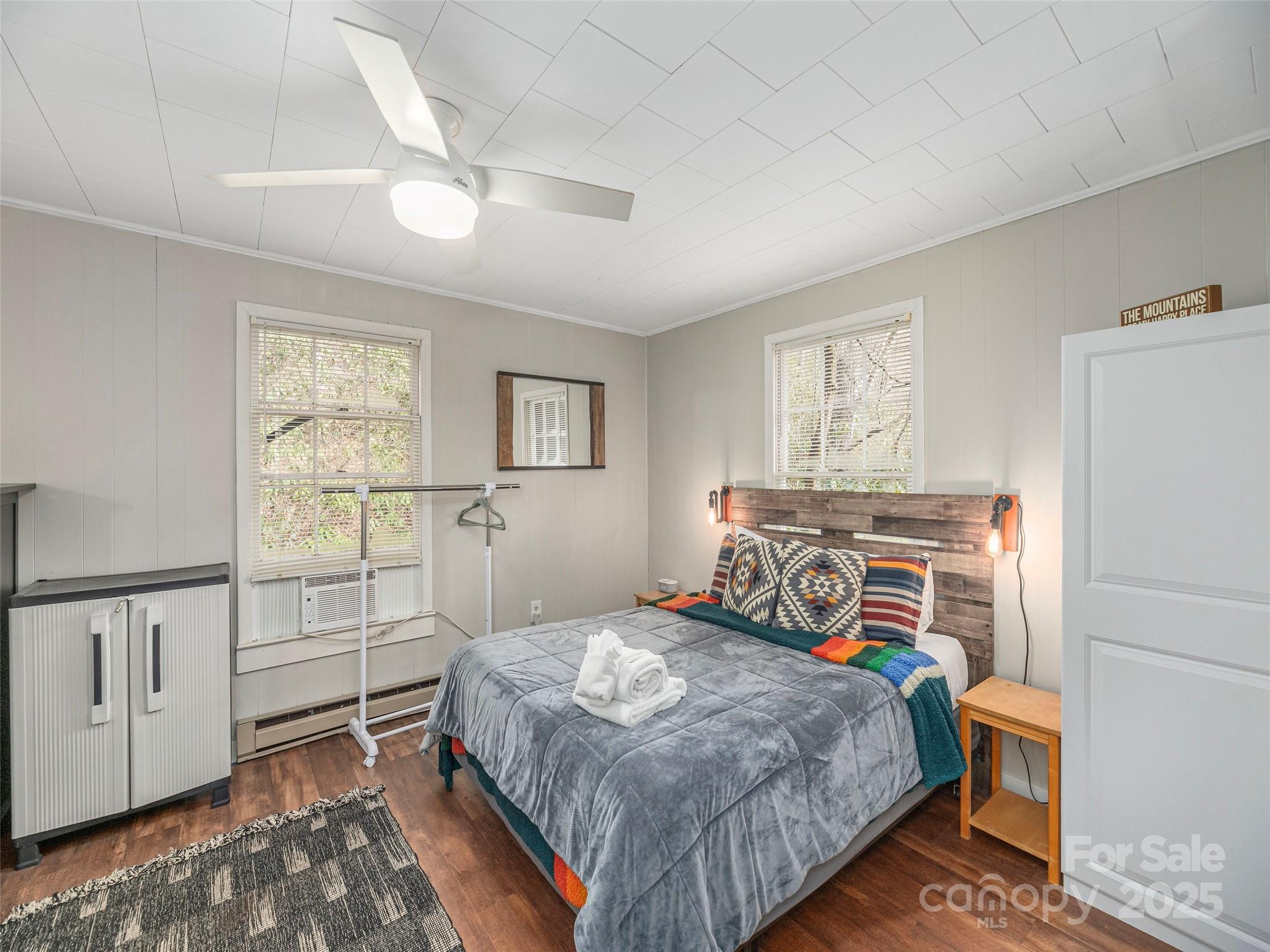 155 Mull Cove Road Maggie Valley, NC 28751 - Photo 10 of 19 a bedroom with a bed and a window