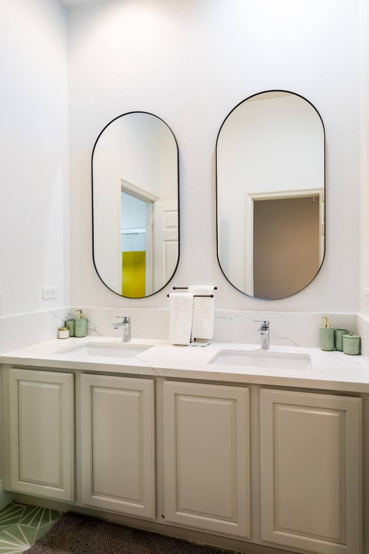 49133 Jordan Street Indio, CA 92201 - Photo 37 of 60 a bathroom with a double vanity sink and a mirror