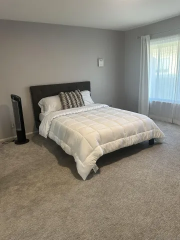 a bedroom with a bed and window