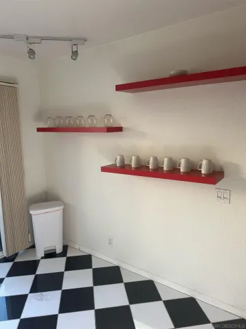 a white cabinet with a black white and white checkered floor
