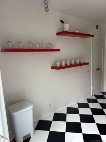 a black and white checkered floor with a rug