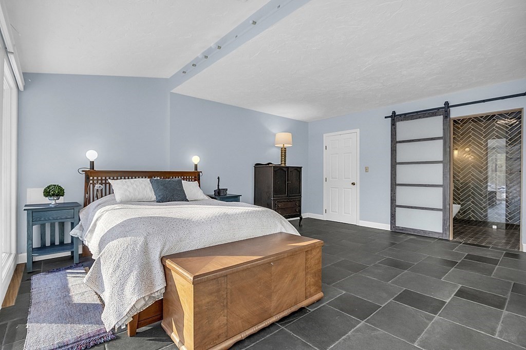 296 Boston Road Groton, MA 01450 - Photo 16 of 42 a bed room with a bed and a mirror