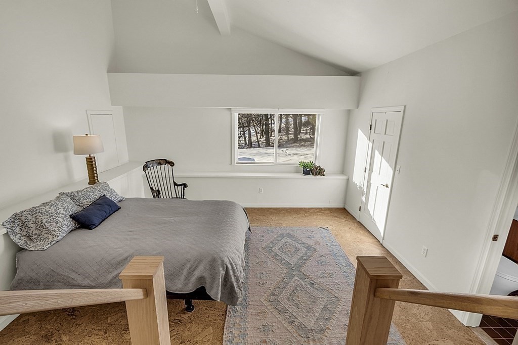 296 Boston Road Groton, MA 01450 - Photo 26 of 42 a bedroom with a bed and wooden floor