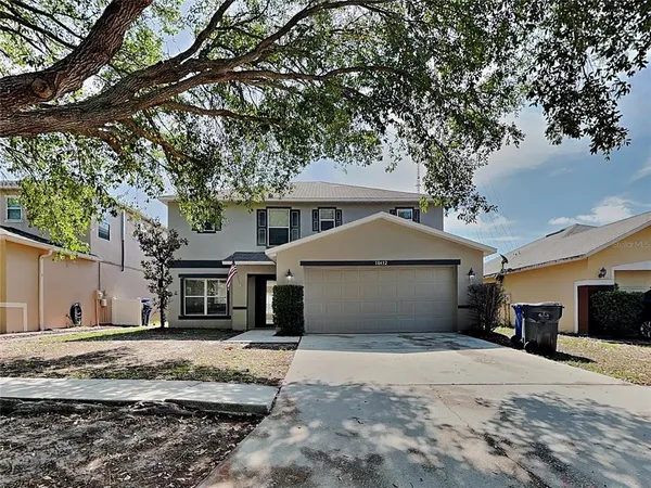 a front view of a house with a yard and garage