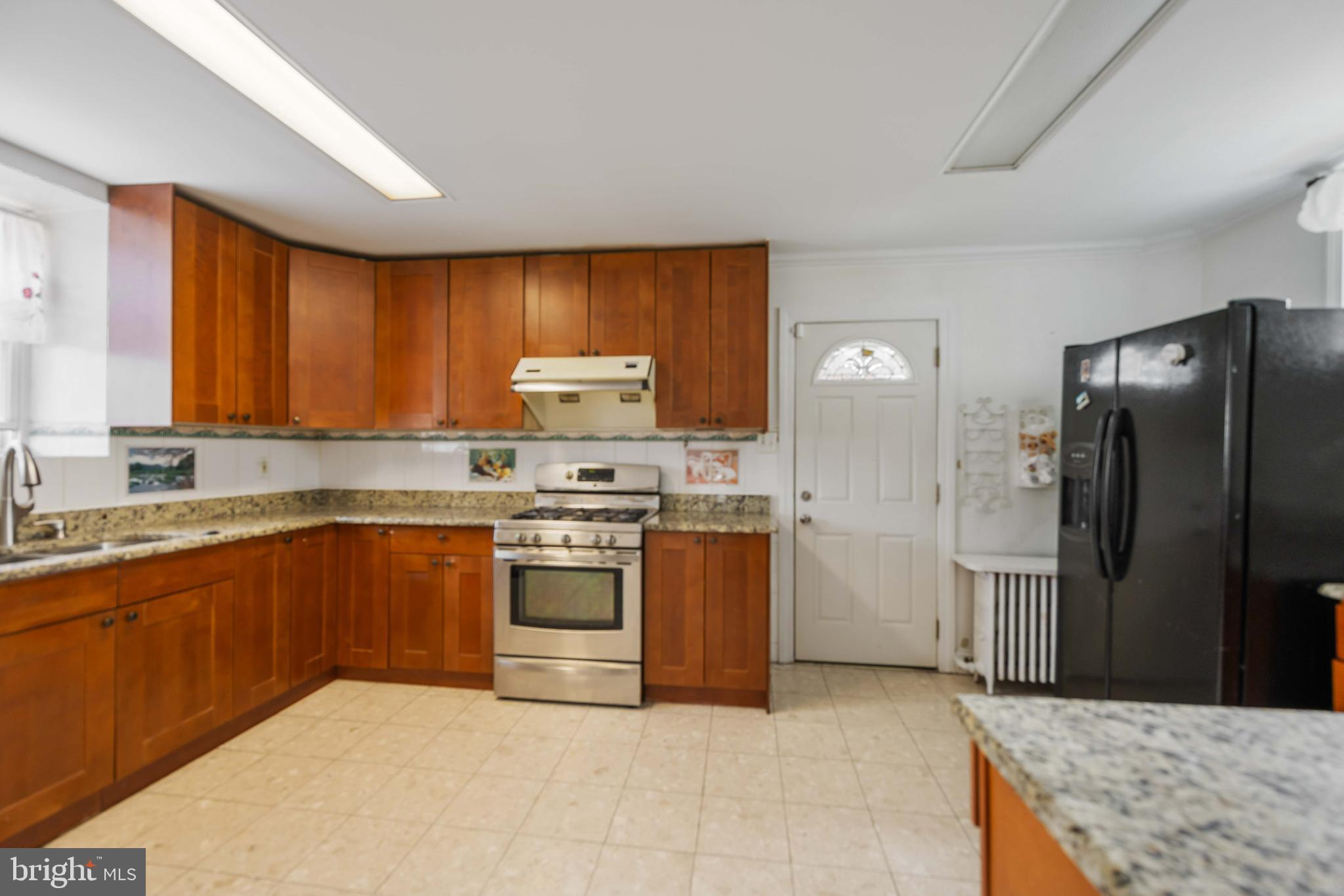537 Elm Avenue Upper Darby, PA 19082 - Photo 14 of 30 a kitchen with stainless steel appliances granite countertop a refrigerator stove and oven
