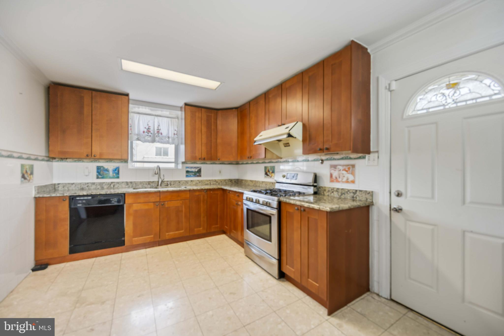 537 Elm Avenue Upper Darby, PA 19082 - Photo 15 of 30 a kitchen with stainless steel appliances granite countertop a stove sink and cabinets