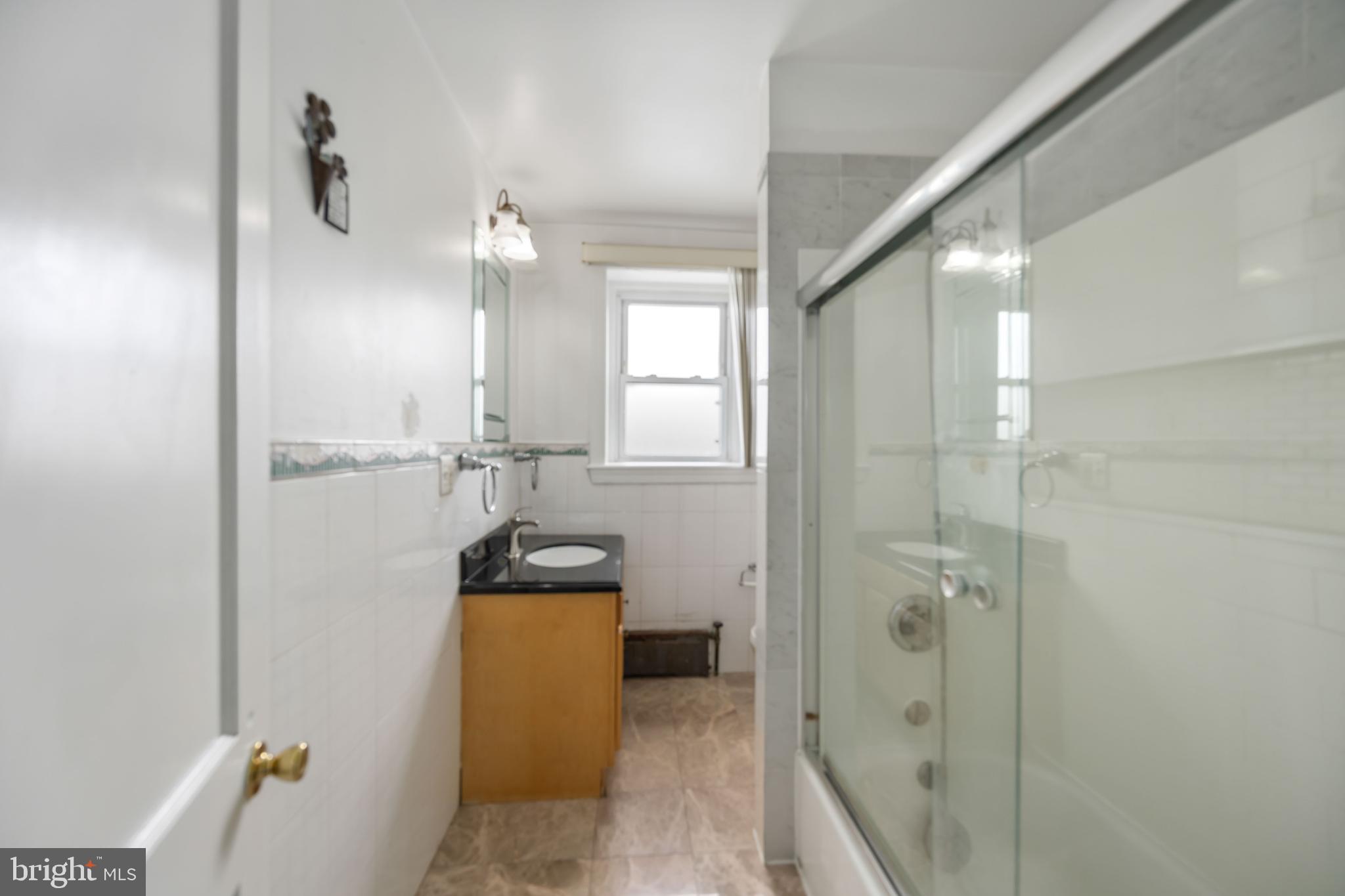 537 Elm Avenue Upper Darby, PA 19082 - Photo 20 of 30 a bathroom with a sink and mirror