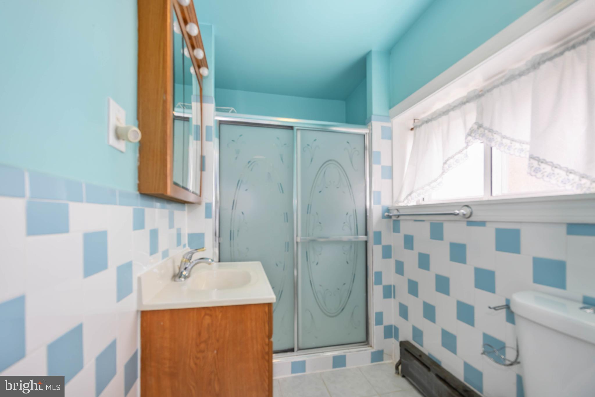 537 Elm Avenue Upper Darby, PA 19082 - Photo 25 of 30 a bathroom with a sink mirror and a shower