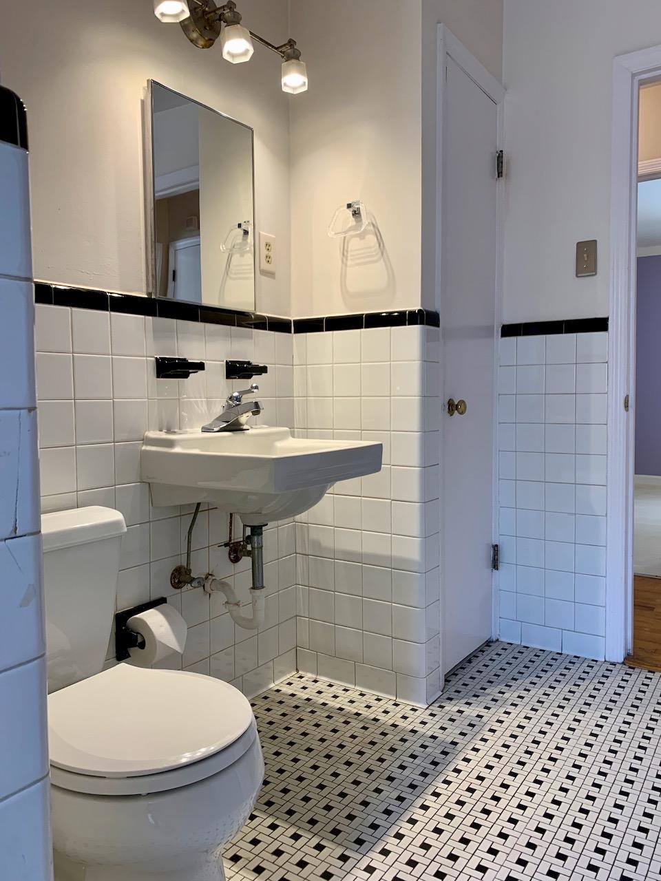 1229 Wilmore Road Memphis, TN 38117 - Photo 11 of 20 a bathroom with a sink a toilet and mirror