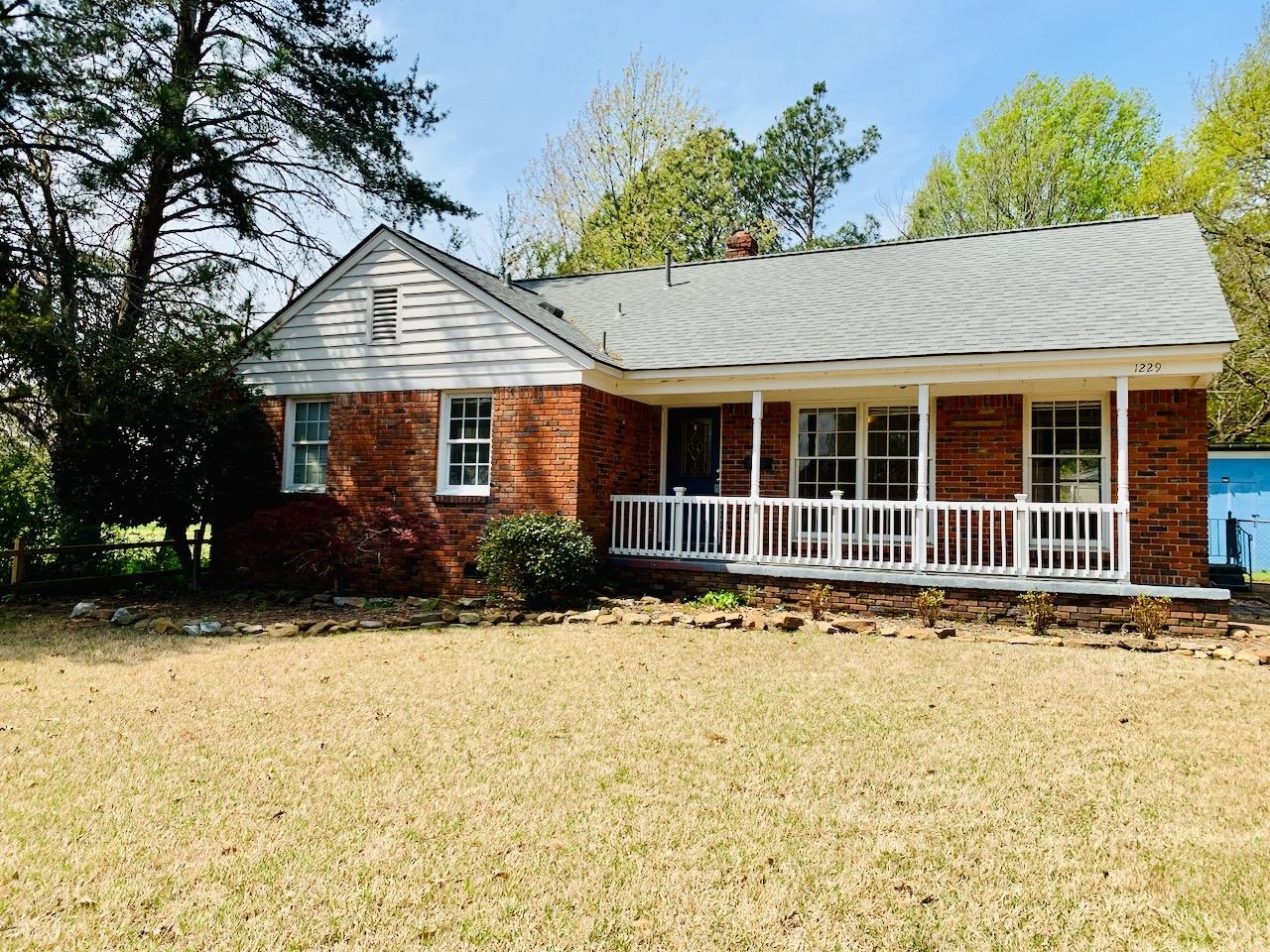 1229 Wilmore Road Memphis, TN 38117 - Photo 2 of 20 a front view of a house with a yard covered with snow in front of house