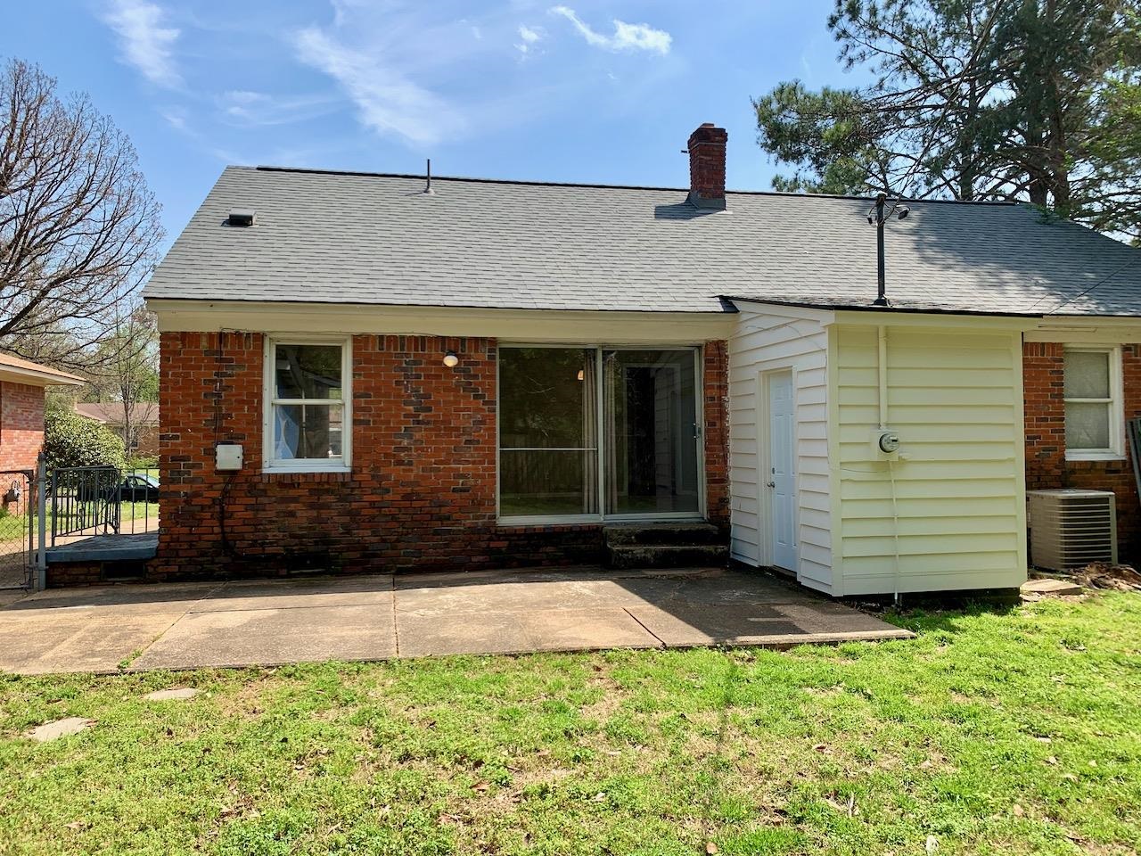1229 Wilmore Road Memphis, TN 38117 - Photo 3 of 20 a front view of a house with a yard