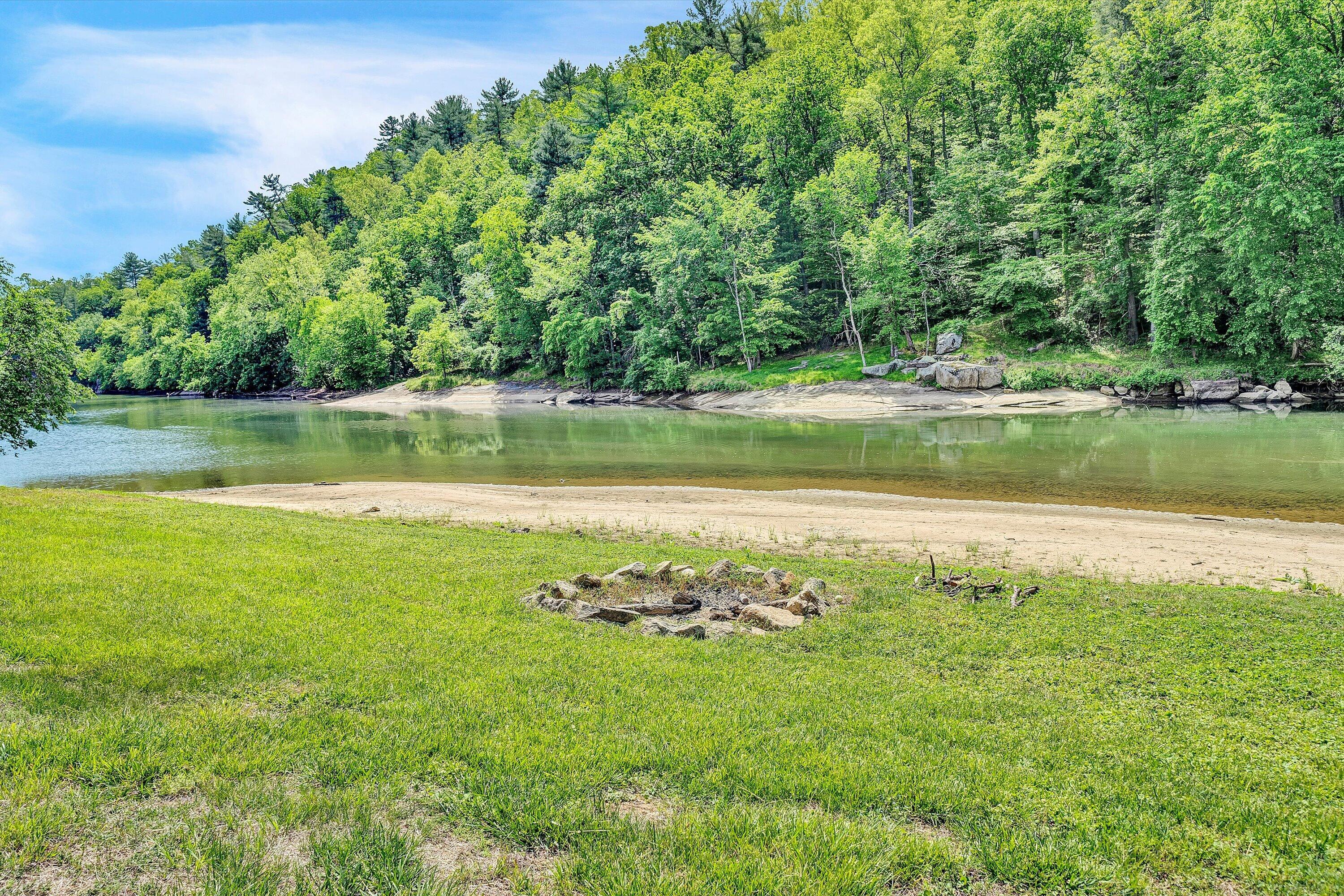 Lot 26 River Rock Road Vinton, VA 24179 - Photo 25 of 28 a view of a lake with a yard and large trees
