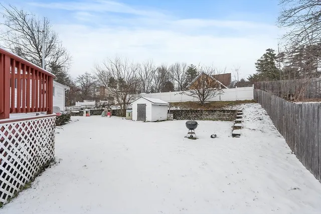 a view of a house with a yard covered in snow